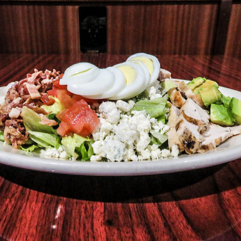Cobb salad with eggs, bacon, avocado, and cheese